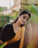 namitha-pramod-in-black-saree-with-orange-border-dress-photos-008