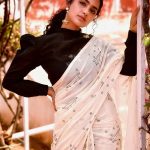 anupama parameswaran in white saree with black full sleeve blouse