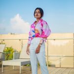 esther anil in white pants and multicolor shirt