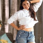 andrea jeremiah in denim shorts and white top photos