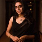 nimisha sajayan in black chiffon saree with sleeveless blouse photos